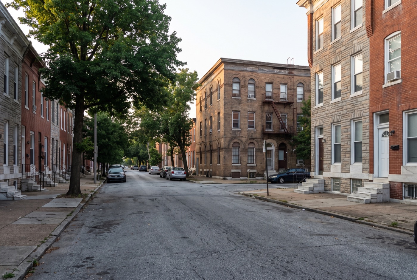 Brick rowhouses and a corner apartment walk-up in Baltimore